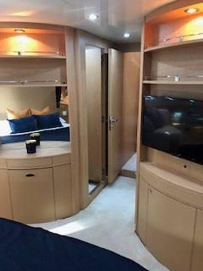 a room with a bed and a shelf with a blue blanket aboard 2013 RIVA 75 VENERE SUPER Yacht for Sale