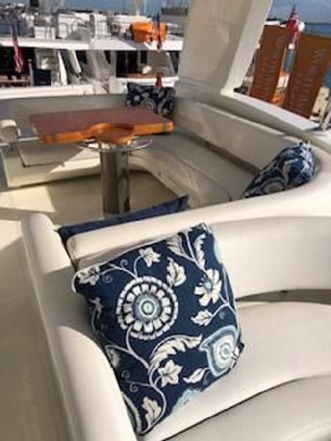 a chair with a table and a stool in the background aboard 2013 RIVA 75 VENERE SUPER Yacht for Sale