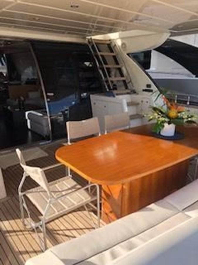 a table and chairs in a room aboard 2013 RIVA 75 VENERE SUPER Yacht for Sale