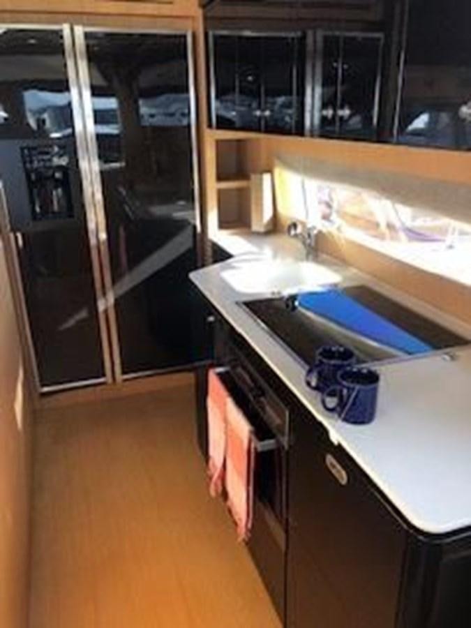 a kitchen with a sink and cabinets aboard 2013 RIVA 75 VENERE SUPER Yacht for Sale