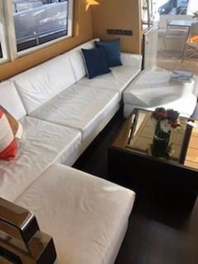 a room with a couch and a table with a window aboard 2013 RIVA 75 VENERE SUPER Yacht for Sale