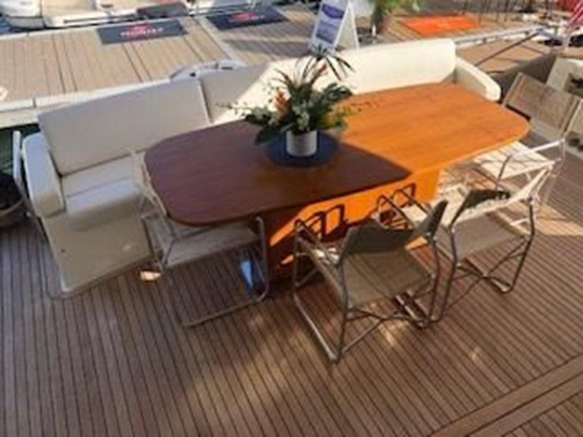 a table and chairs outside aboard 2013 RIVA 75 VENERE SUPER Yacht for Sale