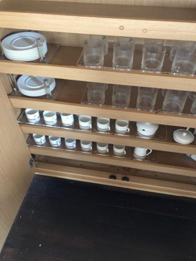 a wooden shelf with many plastic cups on it aboard 2013 RIVA 75 VENERE SUPER Yacht for Sale