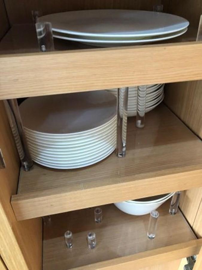 a table with plates and silverware aboard 2013 RIVA 75 VENERE SUPER Yacht for Sale