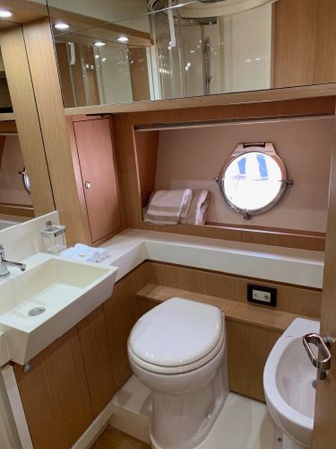 a bathroom with a toilet sink and a mirror aboard 2013 RIVA 75 VENERE SUPER Yacht for Sale