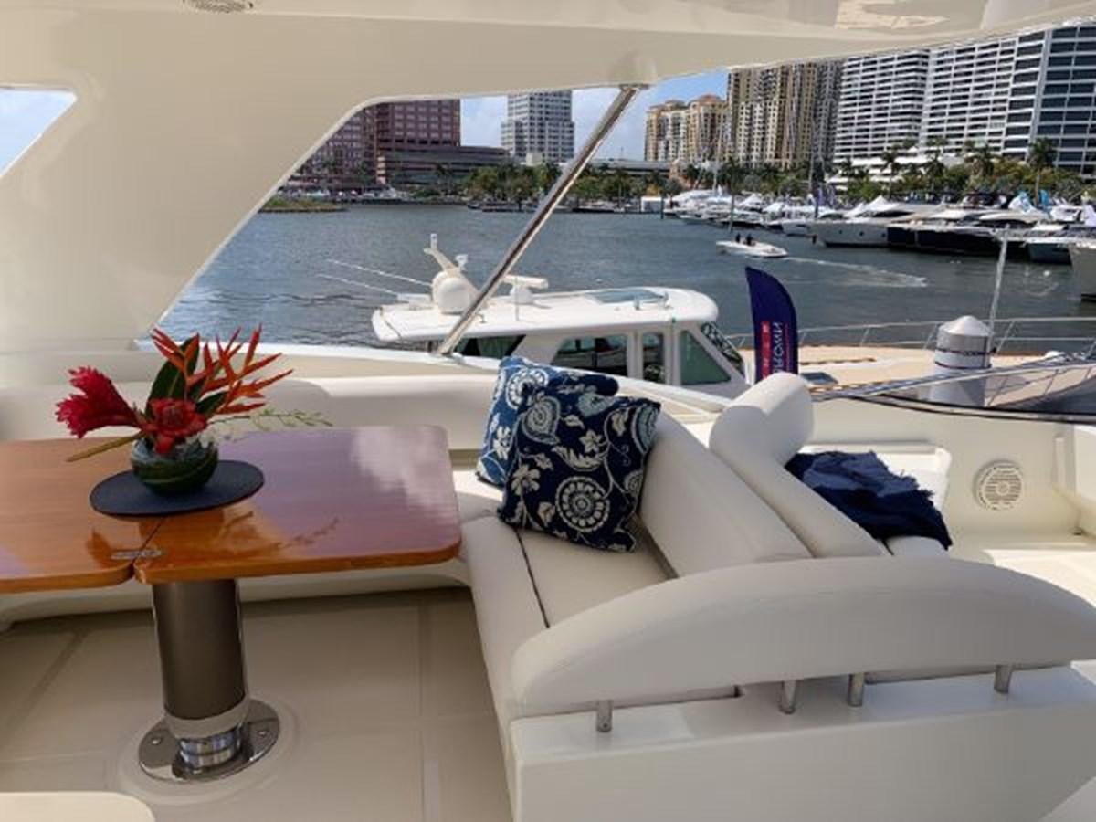 a room with a table and chairs and a plant on a table aboard 2013 RIVA 75 VENERE SUPER Yacht for Sale
