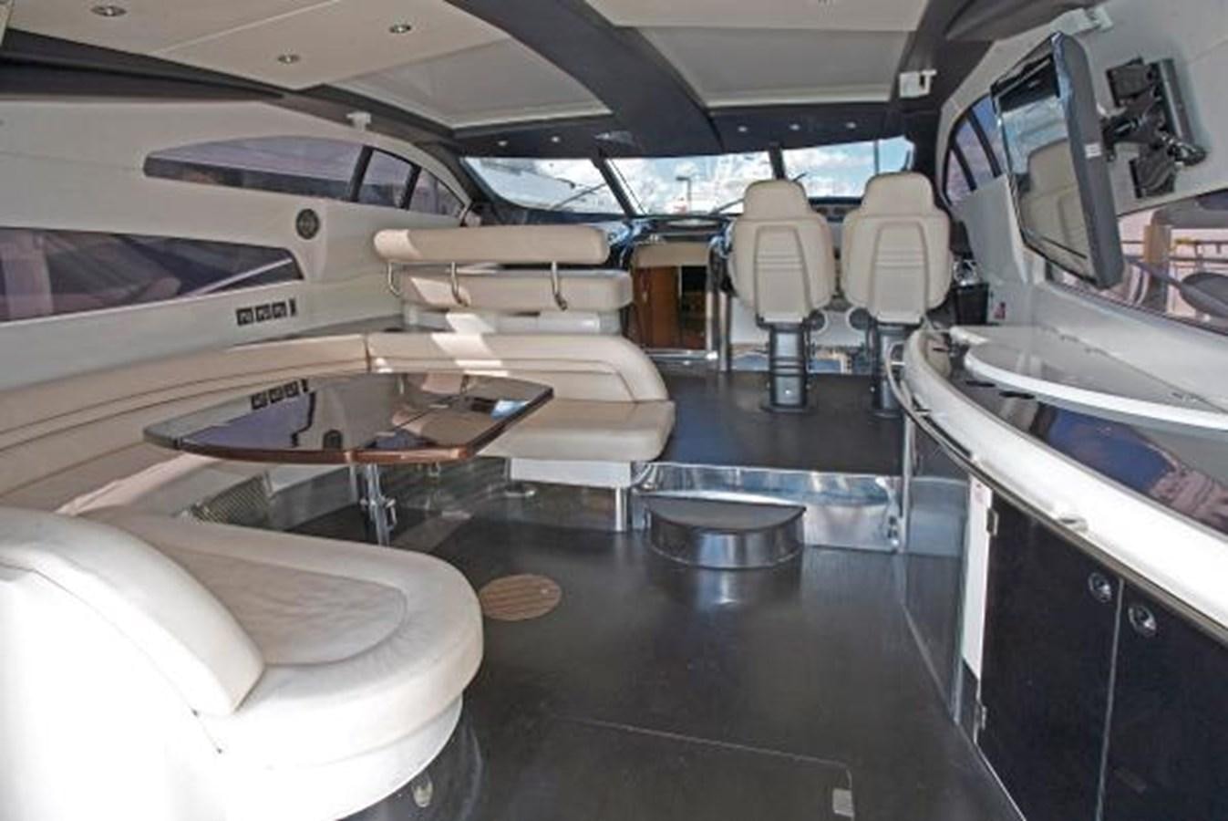 a room with many seats and a plane in it aboard H2 Yacht for Sale