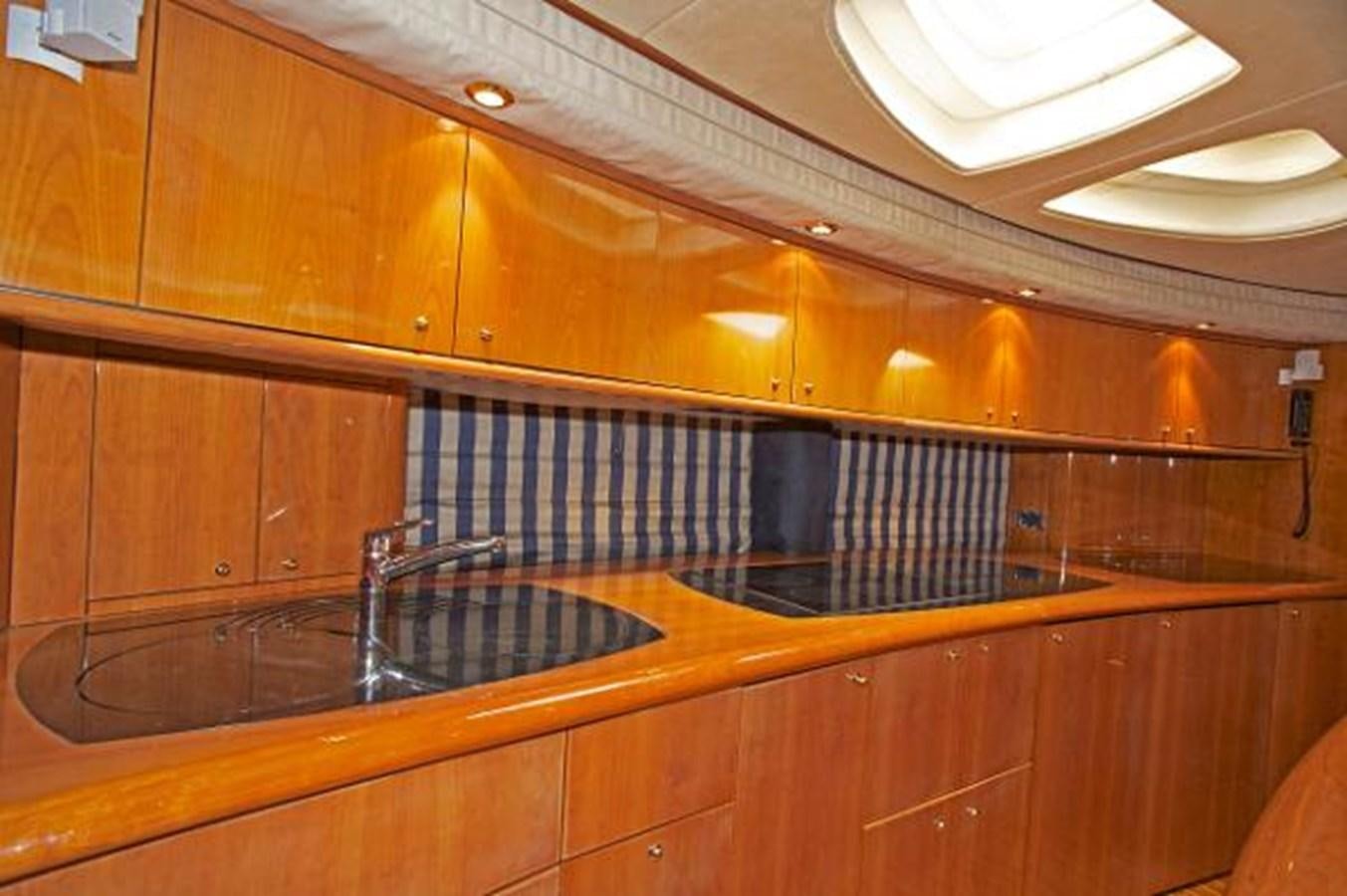 a kitchen with wooden cabinets aboard H2 Yacht for Sale