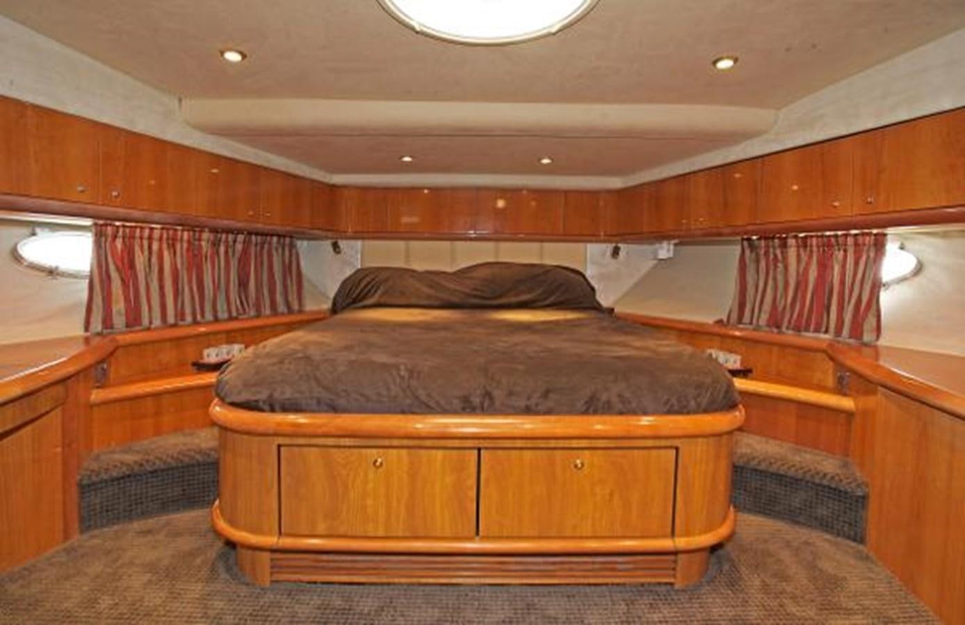 a room with a bed and a wood cabinet aboard H2 Yacht for Sale