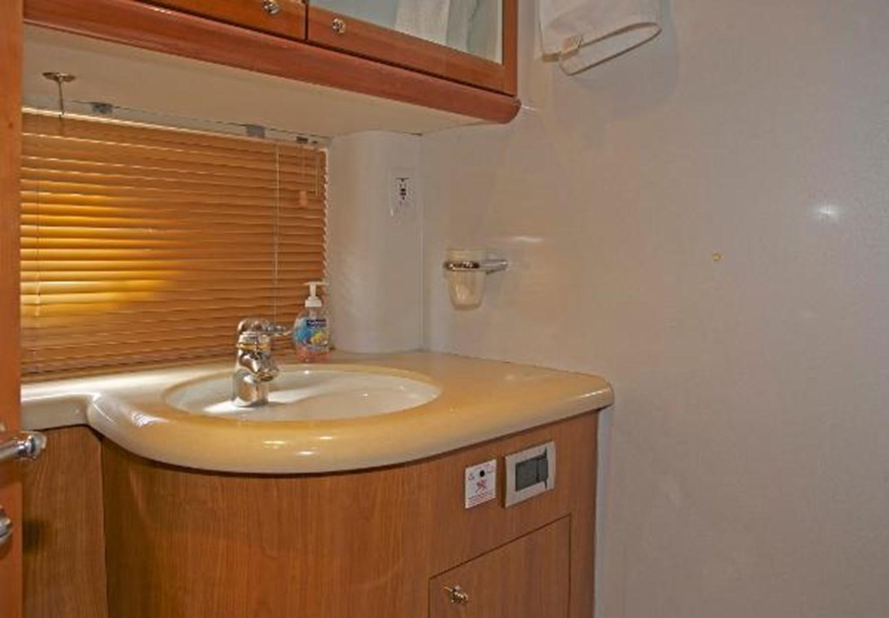 a bathroom with a sink and a mirror aboard H2 Yacht for Sale