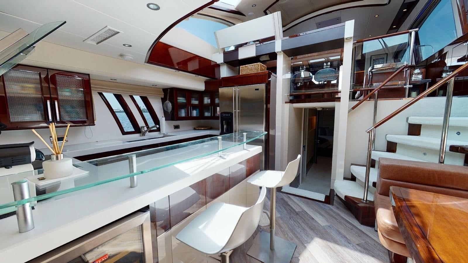 a room with a table and chairs aboard MOJO Yacht for Sale