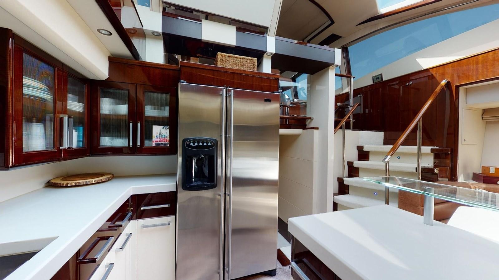 a kitchen with a refrigerator and a microwave oven aboard MOJO Yacht for Sale