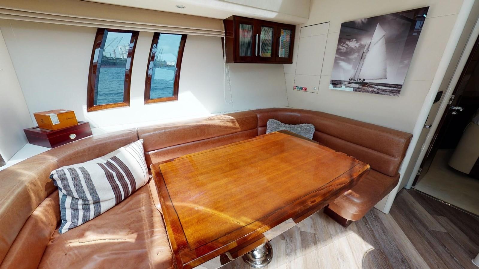 a living room with a couch and a table aboard MOJO Yacht for Sale