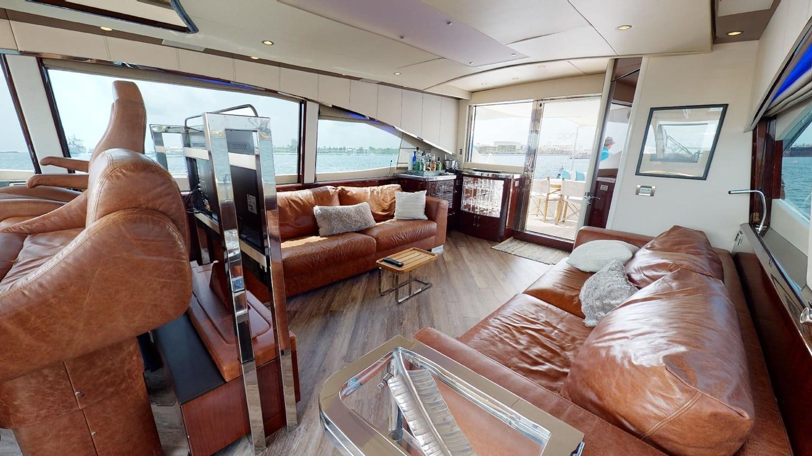 a living room with a couch and a table aboard MOJO Yacht for Sale