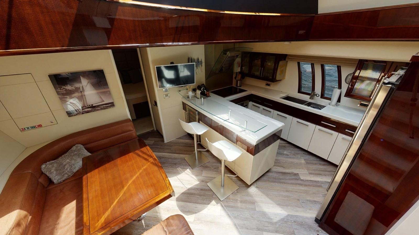 a large kitchen with a couch and a tv aboard MOJO Yacht for Sale