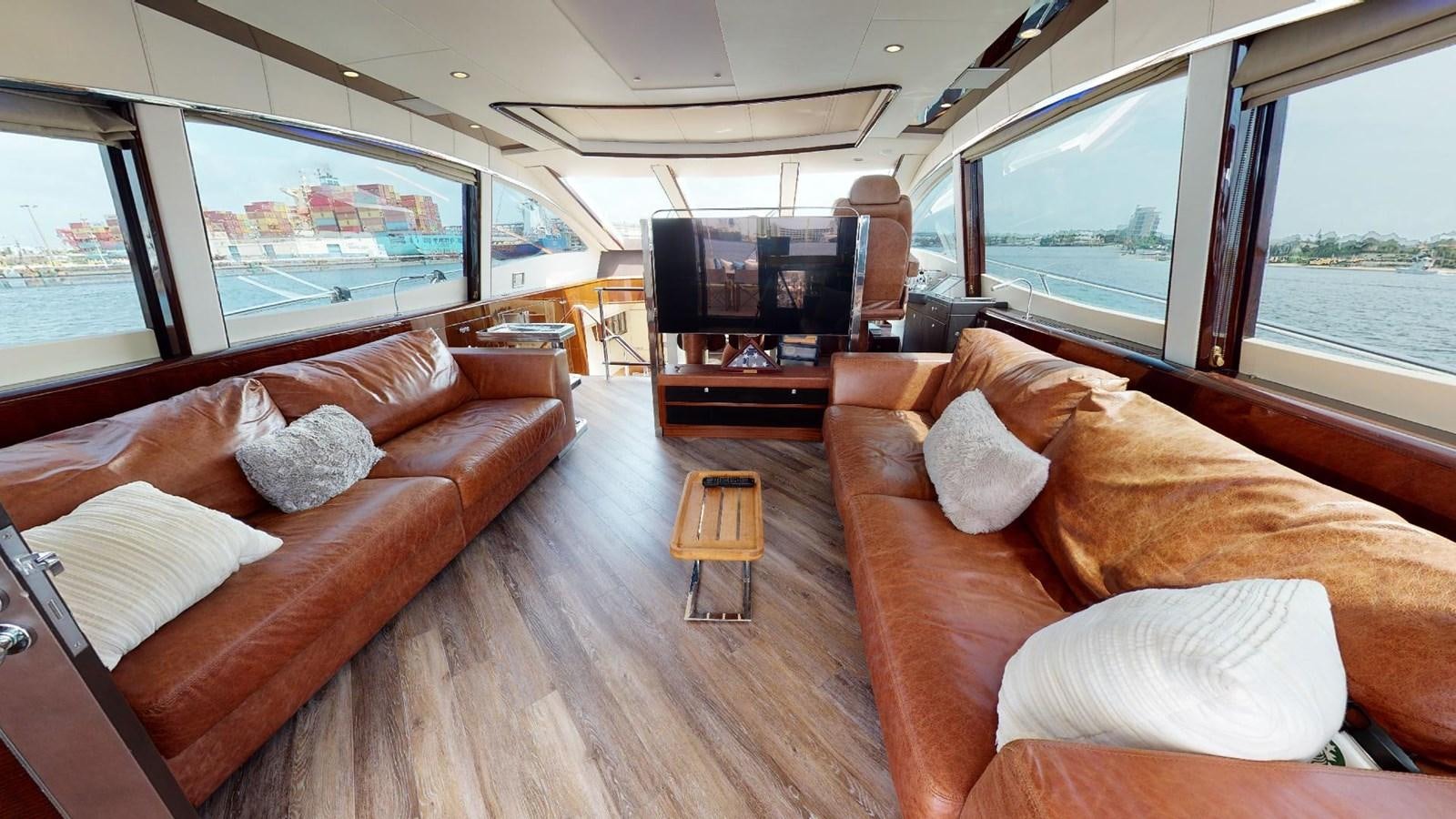 a living room with a couch and a tv aboard MOJO Yacht for Sale