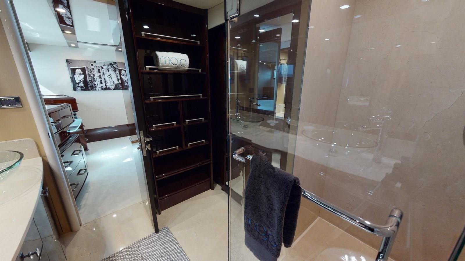 a bathroom with a glass shower aboard MOJO Yacht for Sale