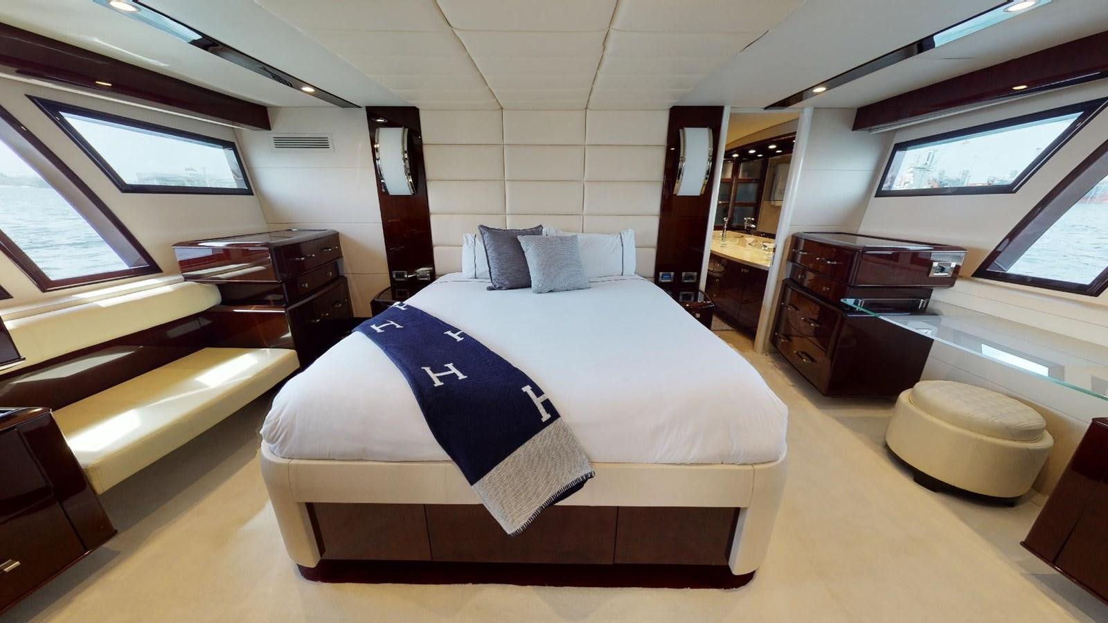 a bedroom with a bed and a desk aboard MOJO Yacht for Sale