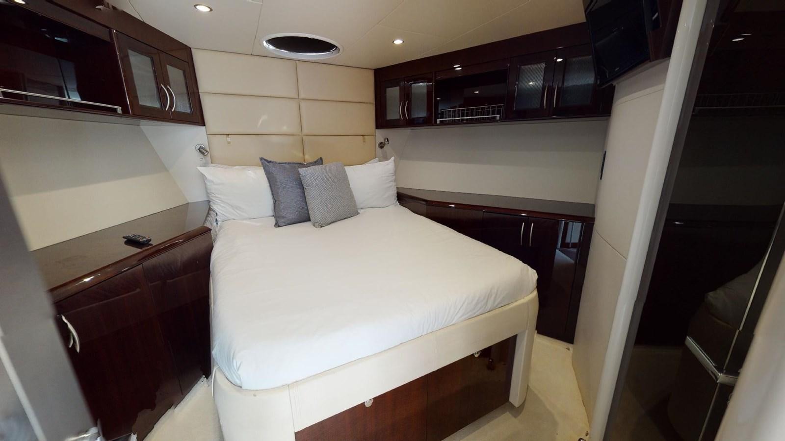 a room with a bed and a desk aboard MOJO Yacht for Sale