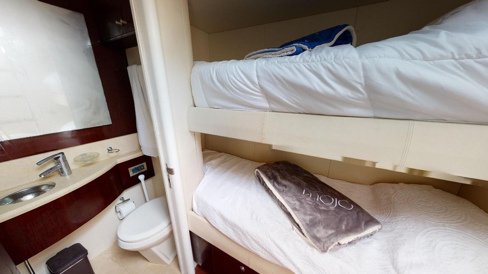 a bed with a sink and a mirror aboard MOJO Yacht for Sale