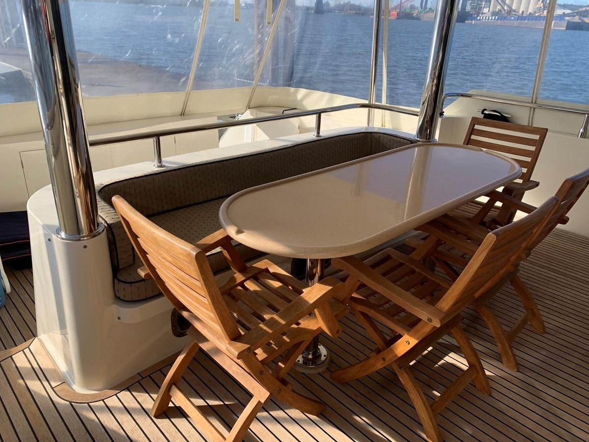 a table and chairs on a deck aboard TAKEN TIME II Yacht for Sale