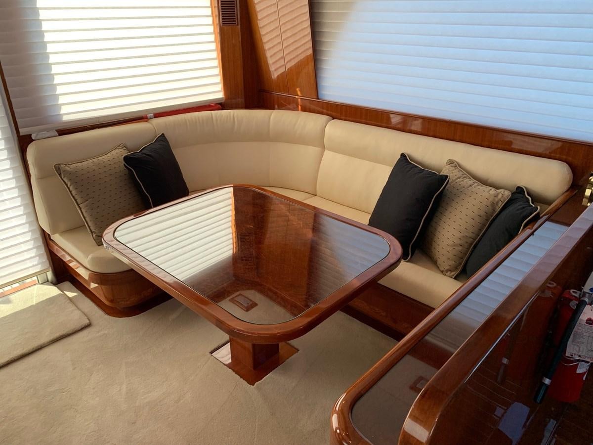 a bed with a table and chairs aboard TAKEN TIME II Yacht for Sale