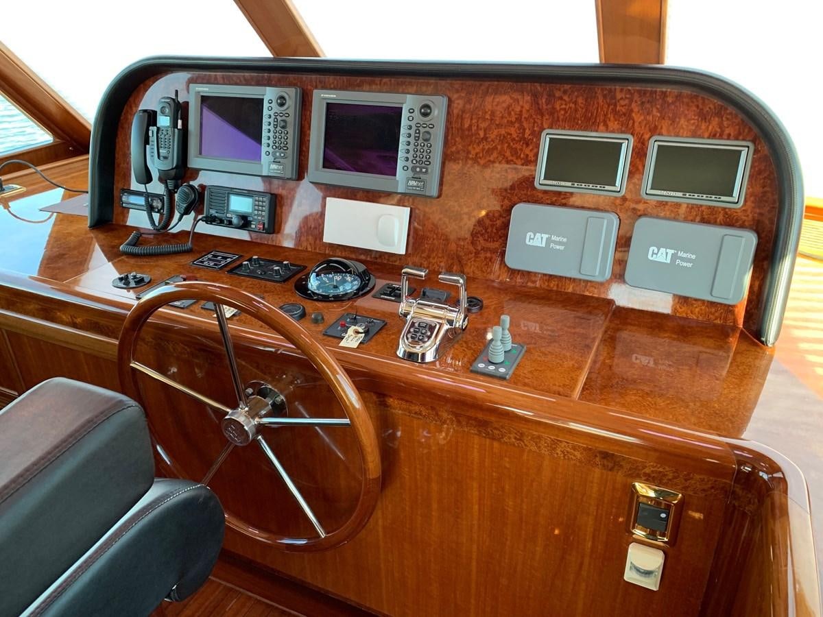 a wooden desk with a computer and other electronics on it aboard TAKEN TIME II Yacht for Sale