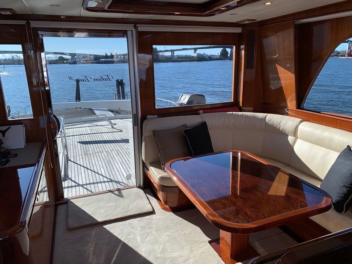 a boat with a table and chairs aboard TAKEN TIME II Yacht for Sale