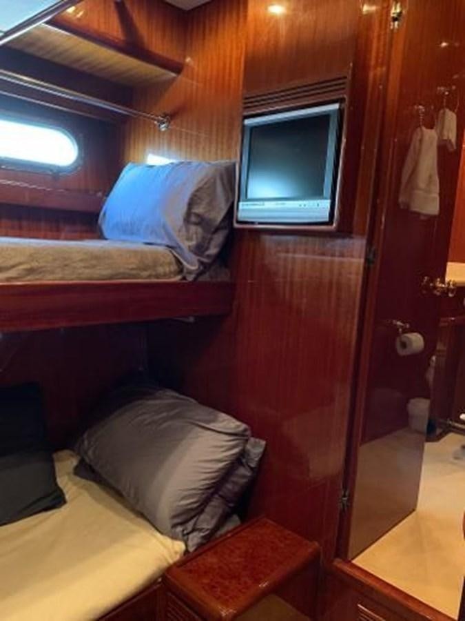 a bed with a television on it aboard TAKEN TIME II Yacht for Sale