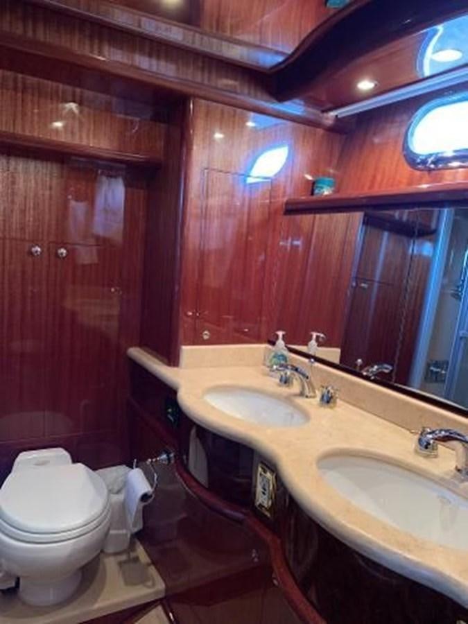 a bathroom with a toilet sink and a mirror aboard TAKEN TIME II Yacht for Sale