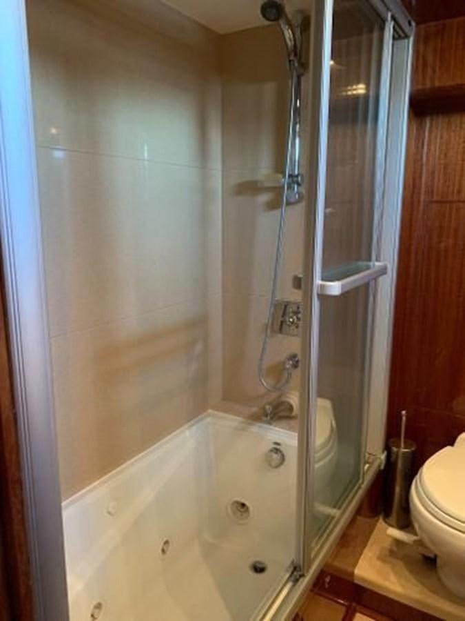 a bathroom with a shower and a sink aboard TAKEN TIME II Yacht for Sale