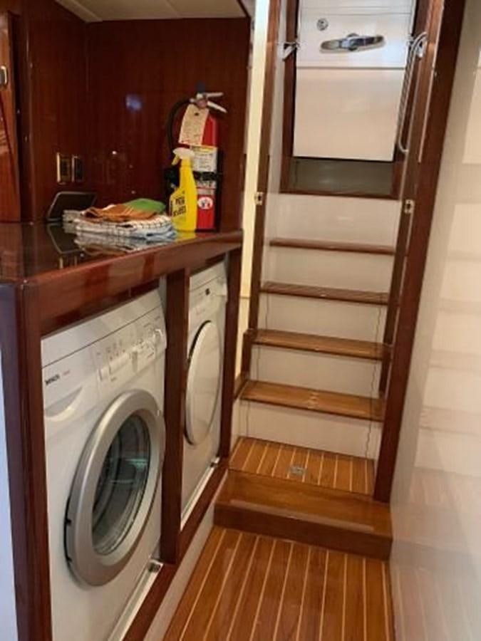 a kitchen with a washer and dryer aboard TAKEN TIME II Yacht for Sale