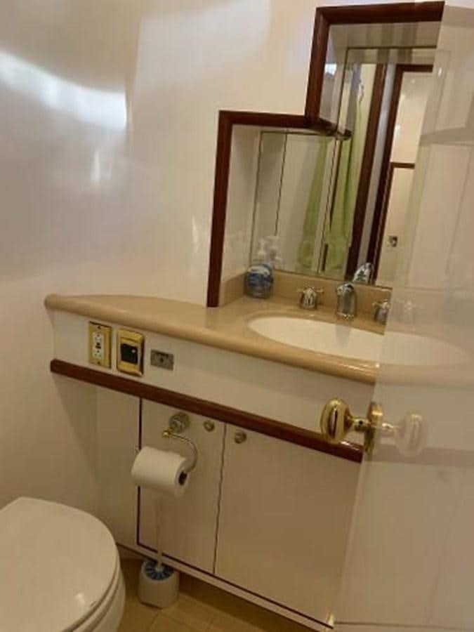 a bathroom with a sink and a toilet aboard TAKEN TIME II Yacht for Sale