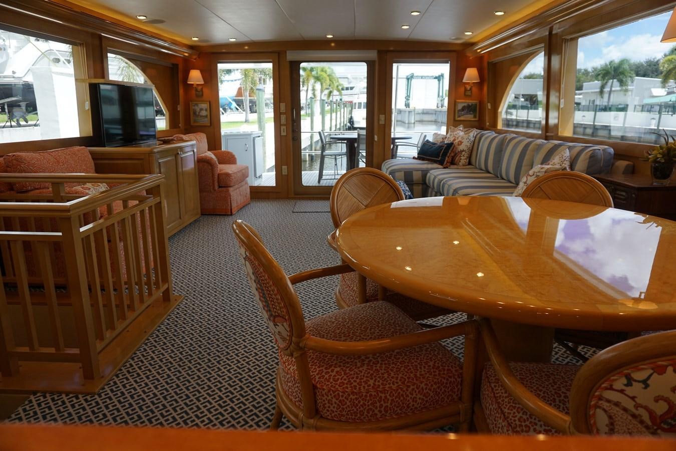 a living room with a table and chairs aboard LUISA Yacht for Sale