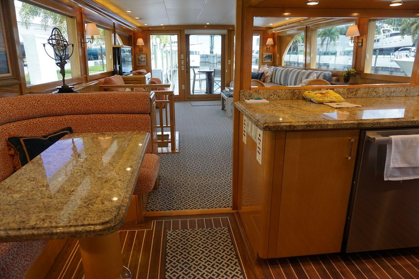 a kitchen with a table and chairs aboard LUISA Yacht for Sale