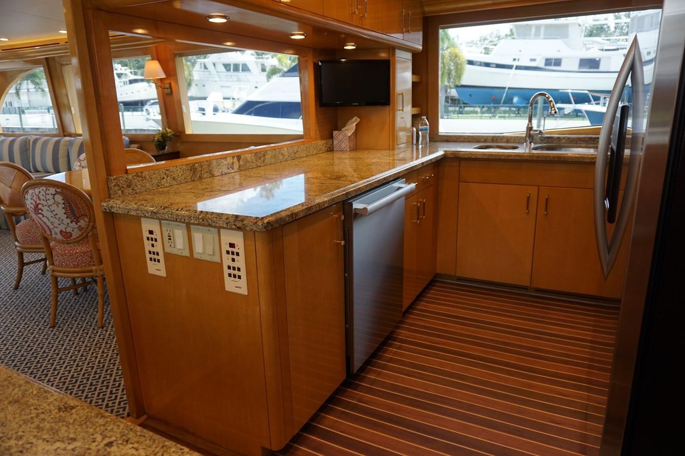 a kitchen with wooden cabinets aboard LUISA Yacht for Sale