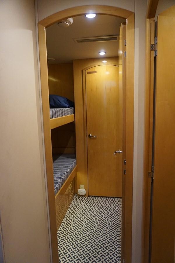 a hallway with a bed and a door aboard LUISA Yacht for Sale