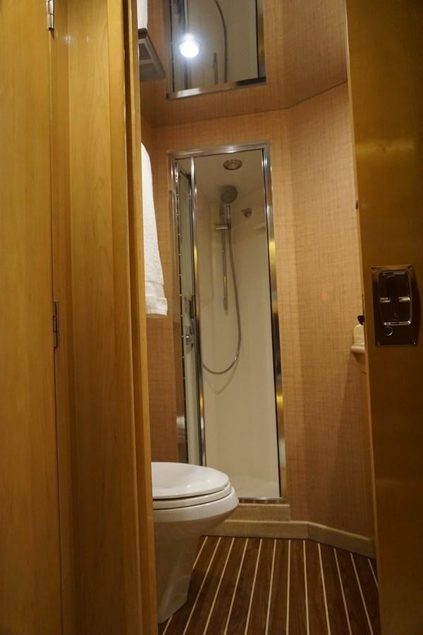 a bathroom with a toilet and a shower unit aboard LUISA Yacht for Sale