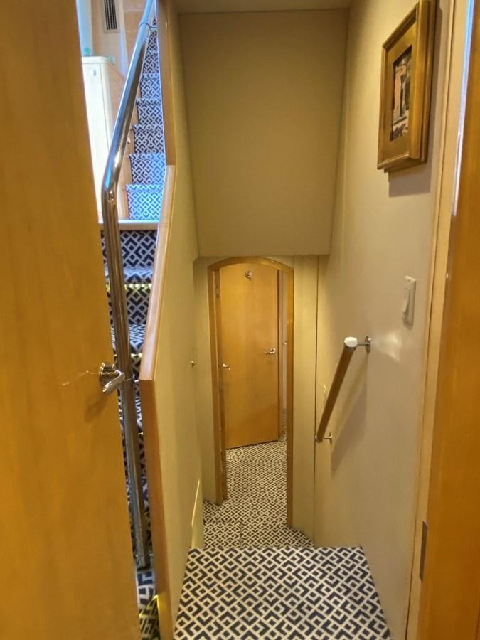 a hallway with a door and a railing aboard LUISA Yacht for Sale