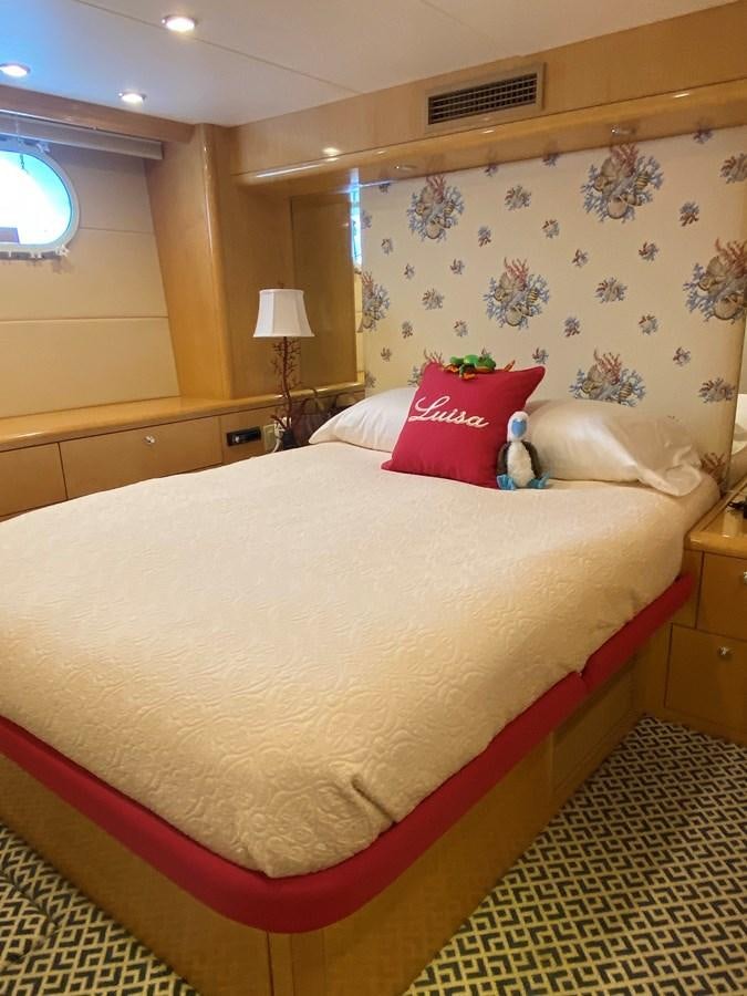 a bed with a pillow and a blanket on it aboard LUISA Yacht for Sale