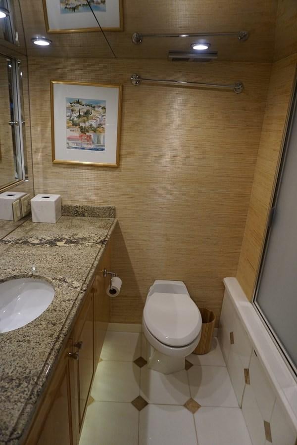 a bathroom with a toilet and sink aboard LUISA Yacht for Sale