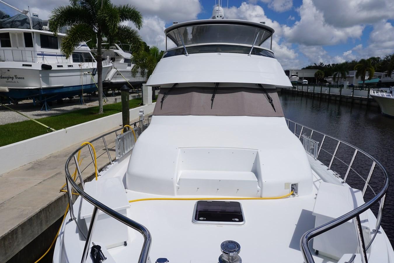 a white yacht in a harbor aboard LUISA Yacht for Sale