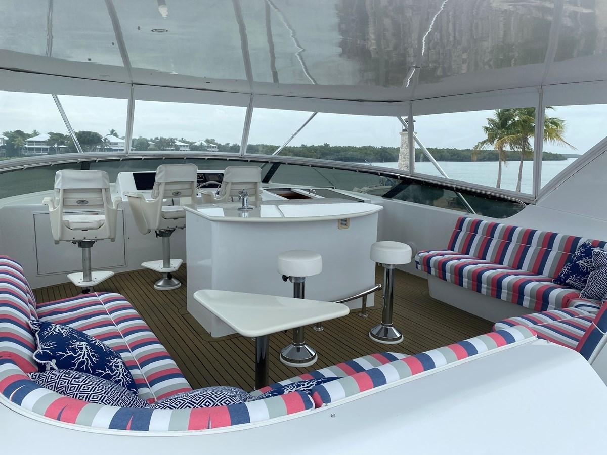 a room with a table and chairs aboard LUISA Yacht for Sale