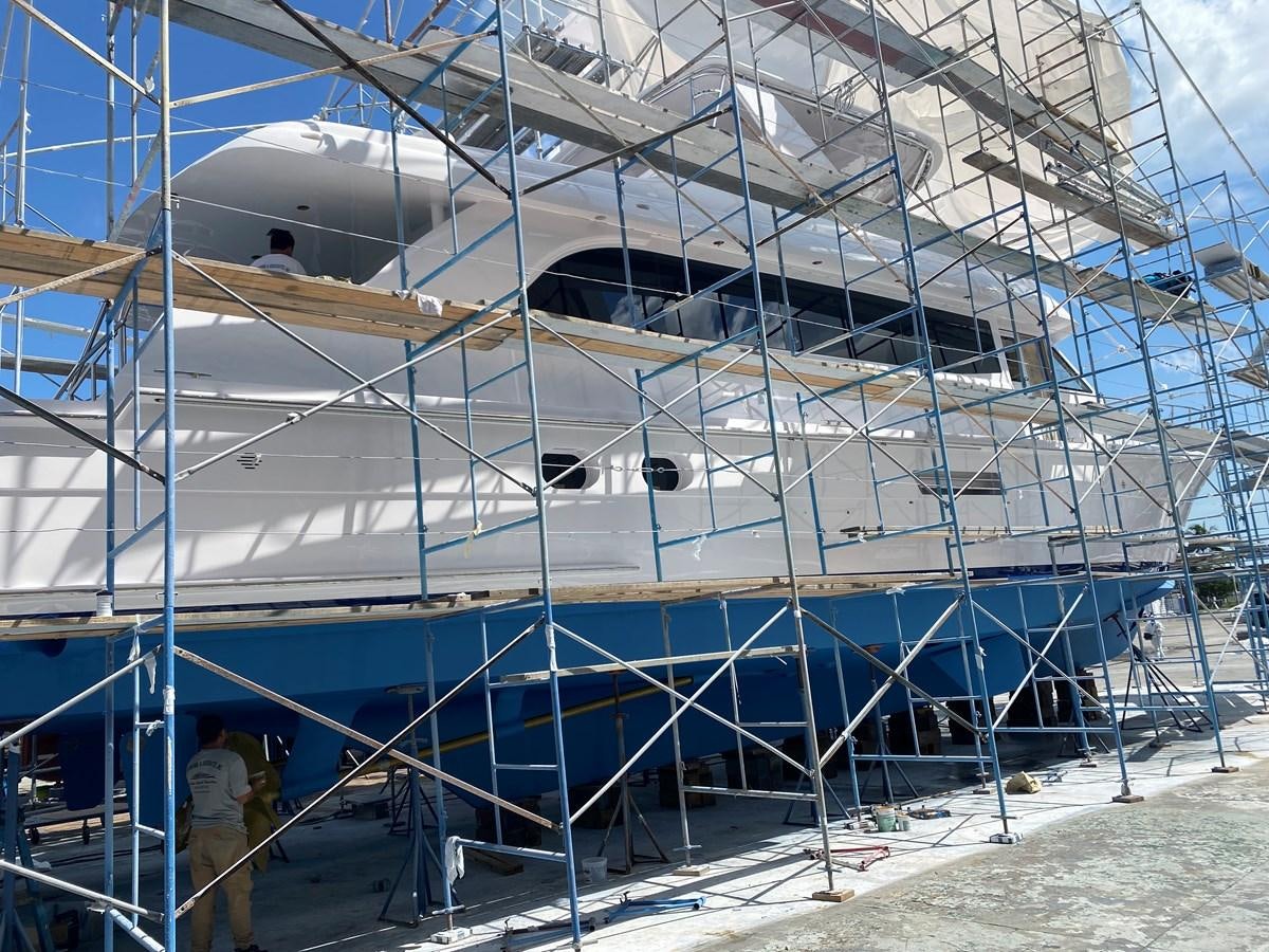 a person standing next to a large white building aboard LUISA Yacht for Sale