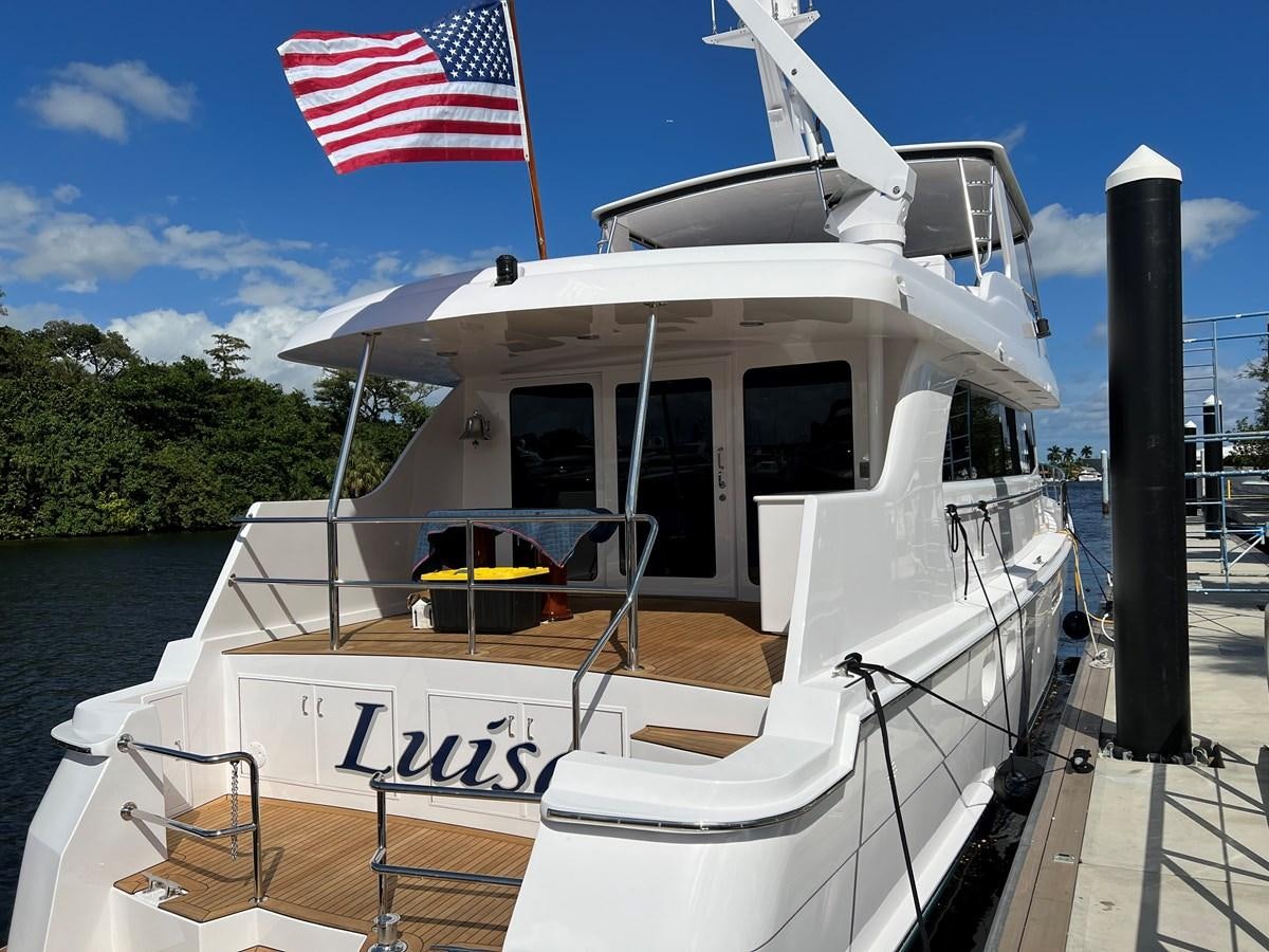 a boat with a flag on the front aboard LUISA Yacht for Sale