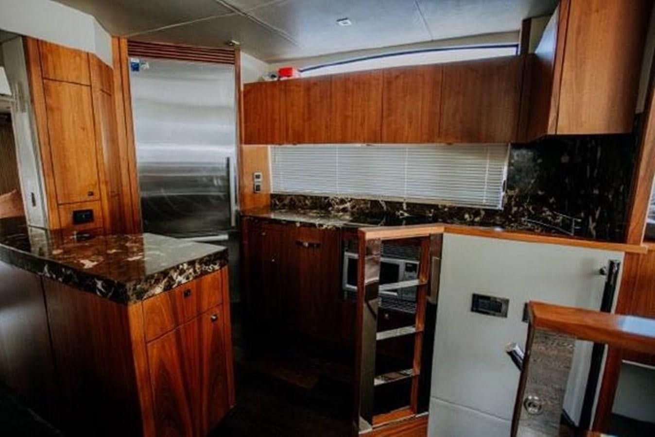 a kitchen with wooden cabinets aboard ASTUR Yacht for Sale