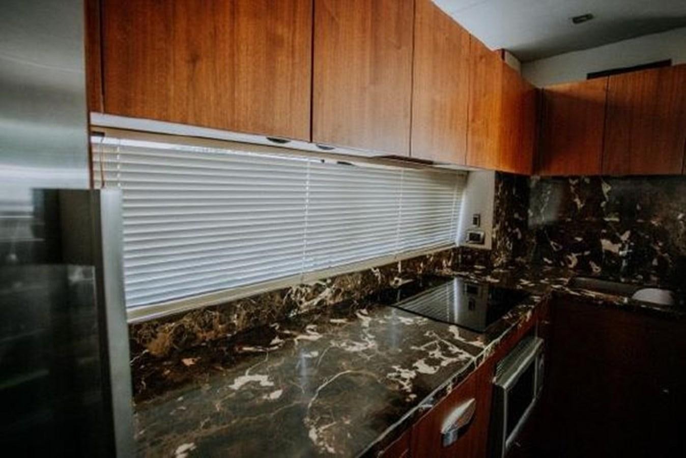 a kitchen with a marble counter top aboard ASTUR Yacht for Sale