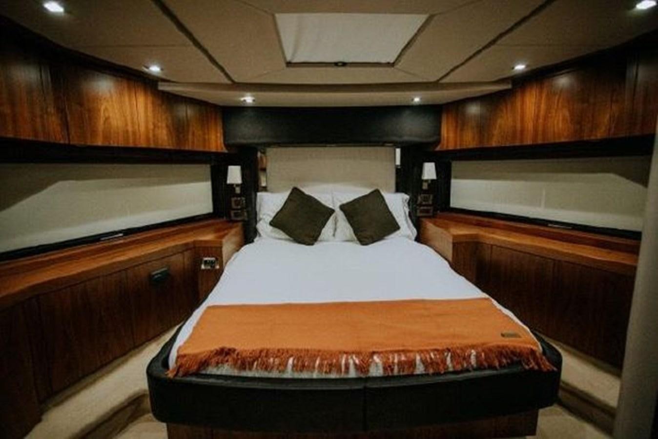 a room with a bed and a dresser aboard ASTUR Yacht for Sale