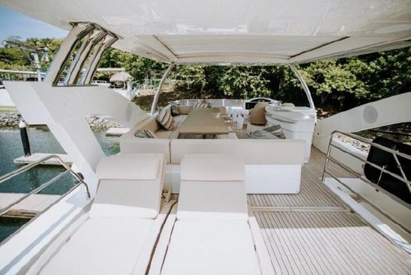 a patio with a deck and chairs aboard ASTUR Yacht for Sale