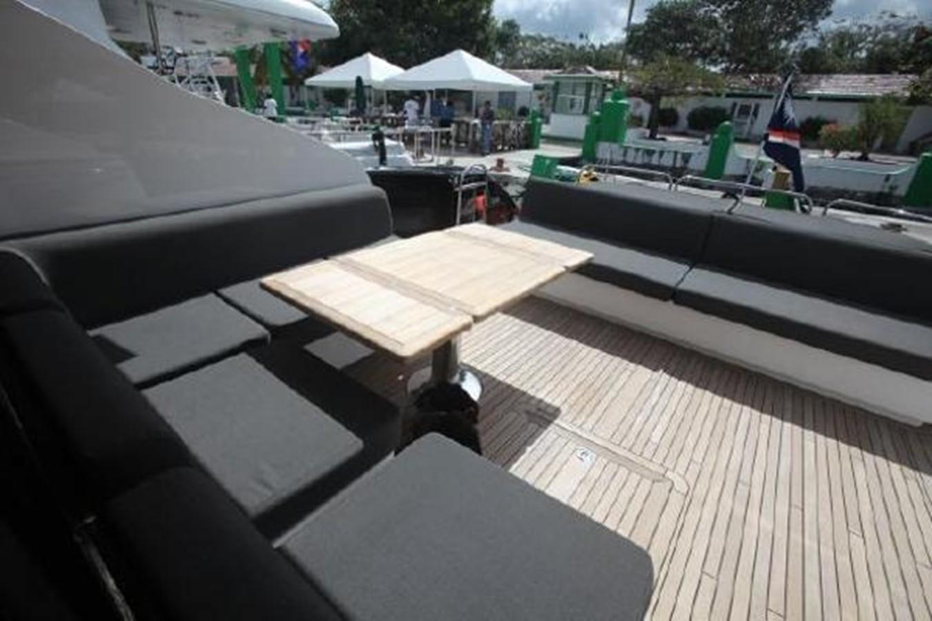 a deck with a table and chairs aboard SAM JADE Yacht for Sale